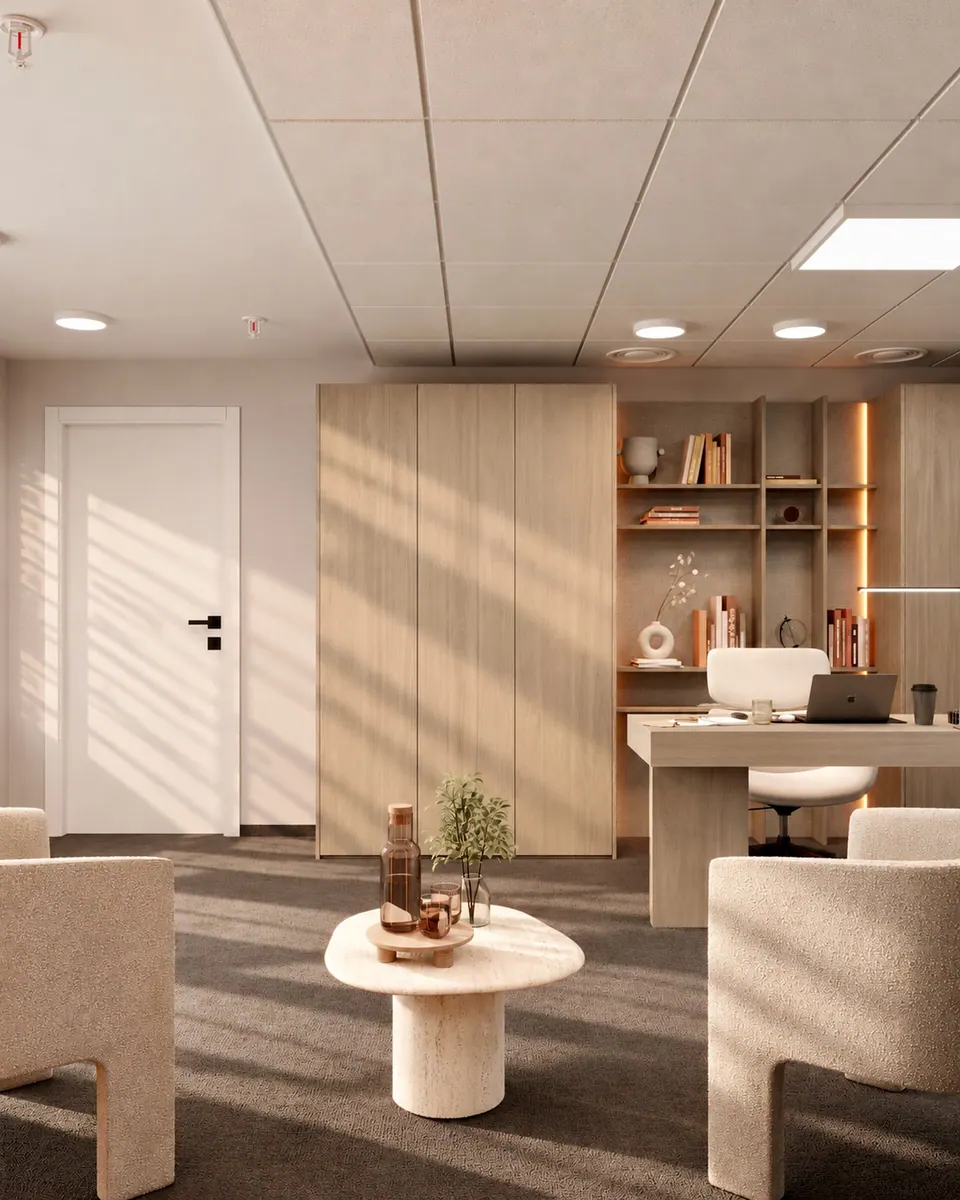 Reception waiting area with soft armchairs and a wall panel