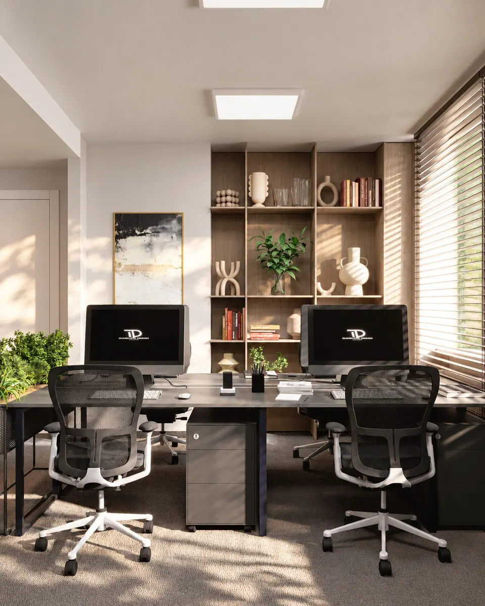 Dark desks, an open shelving unit with décor and monitors