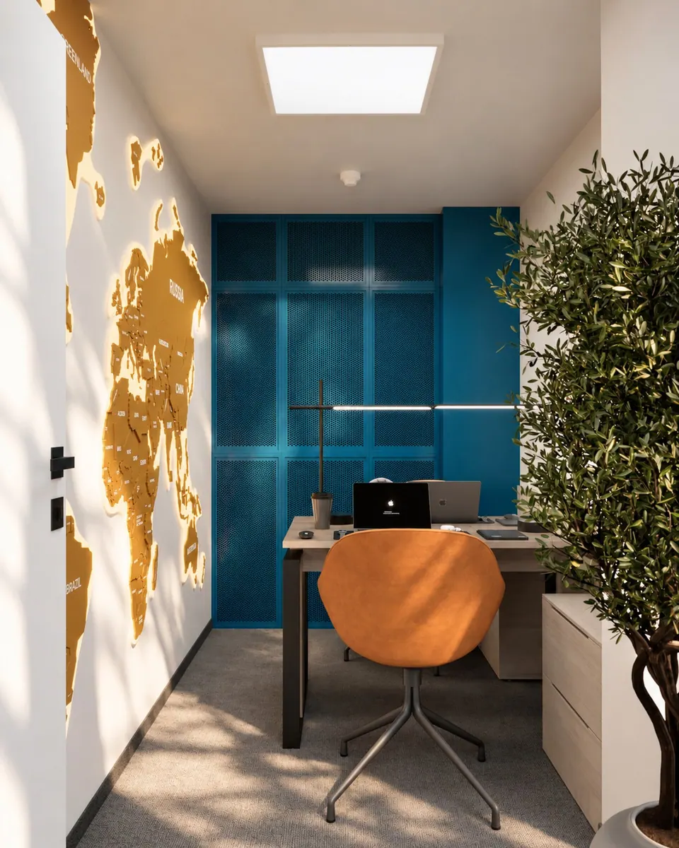 Workstation with an orange chair against a blue panel