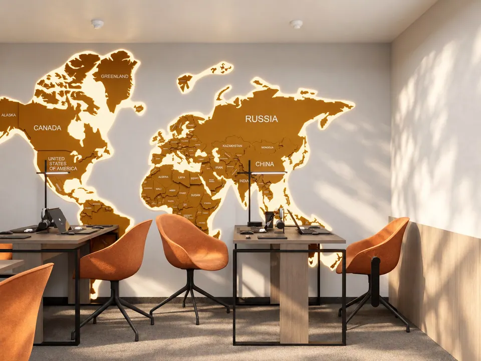 Backlit world map above the workstations