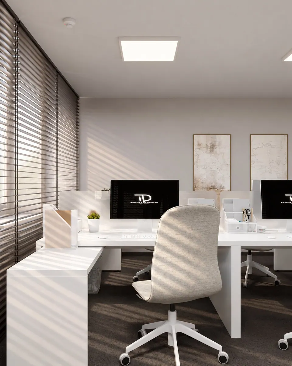 White desks with monitors and upholstered office chairs