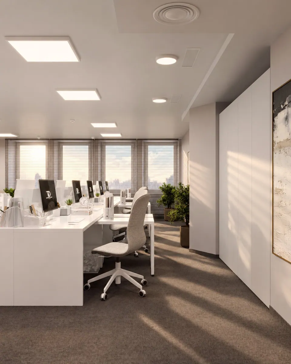 General view of the open-plan workspace with white desks