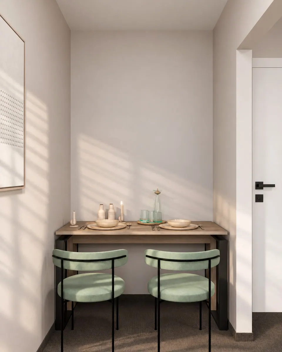 Dining area: table and chairs by a wall with a poster